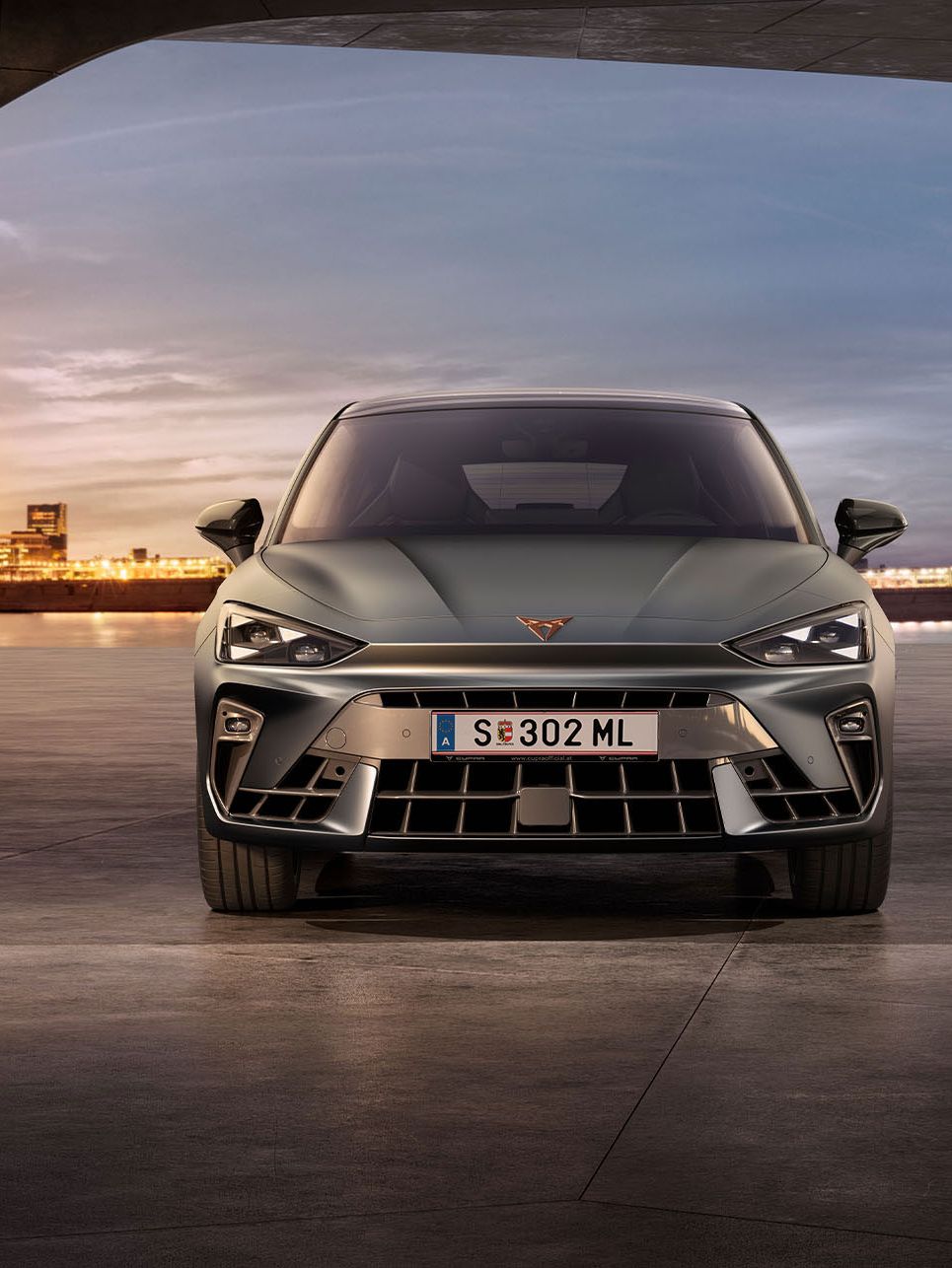 Frontansicht eines grauen CUPRA Leon in einem modernen Parkhaus.