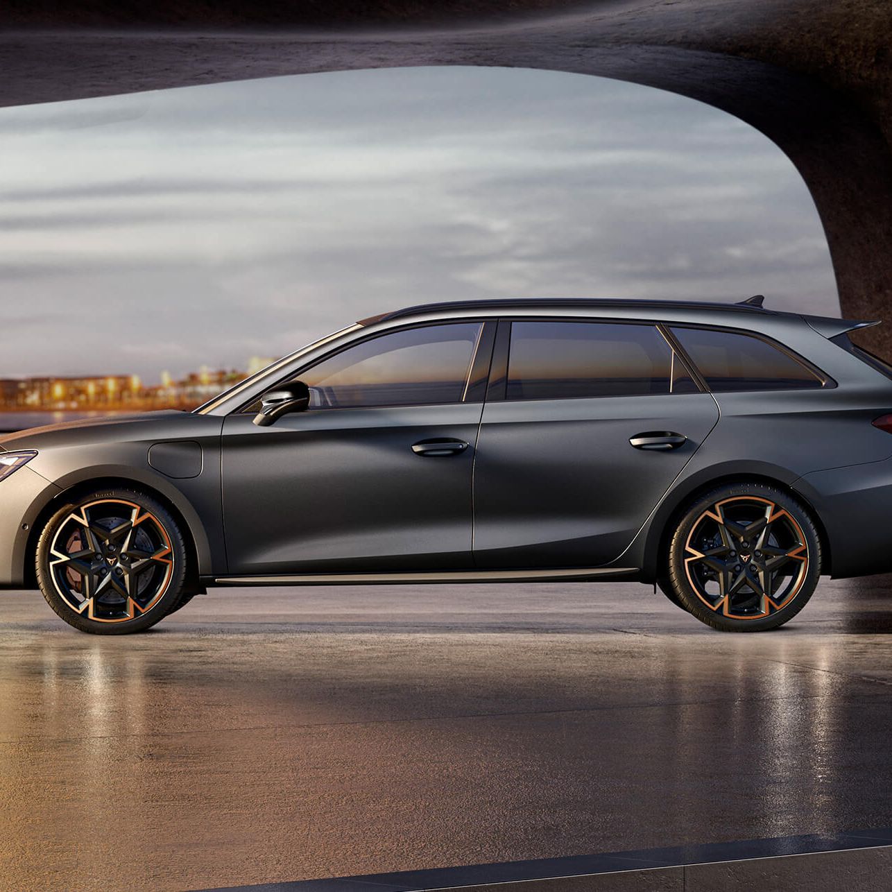 Seitenansicht eines grauen CUPRA Leon SP Kombi in einem modernen Parkhaus.