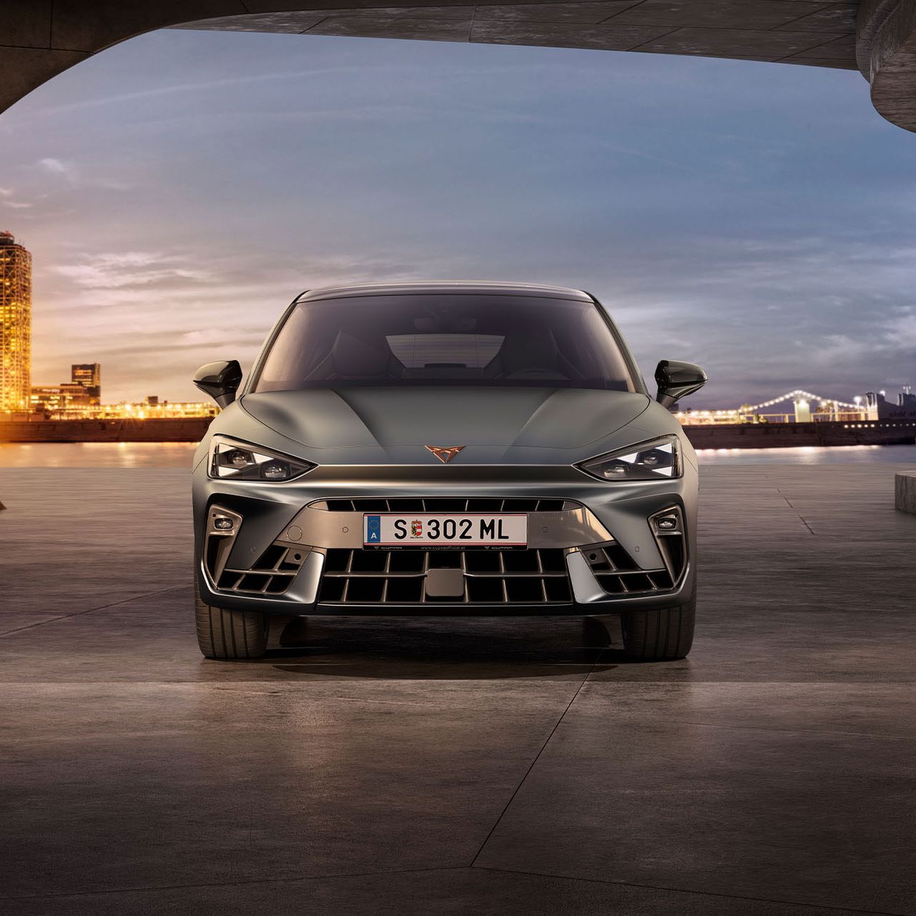 Frontansicht eines grauen CUPRA Leon in einem modernen Parkhaus.