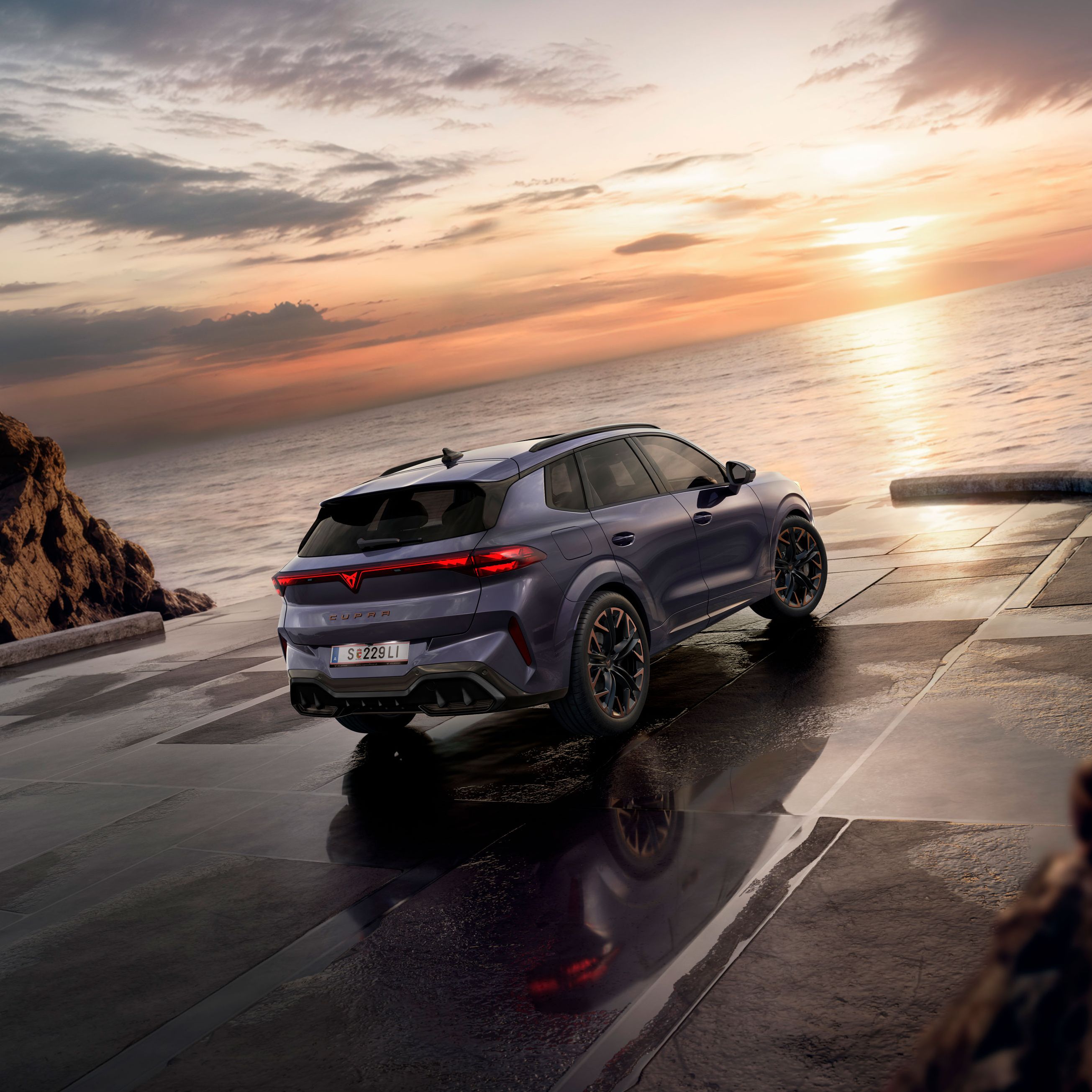 Ein CUPRA Terramar parkt zwischen Klippen am Meer. 